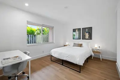 a white bedroom with a bed and a window at Sailors Rest @ Sailboat Bend in Fort Lauderdale