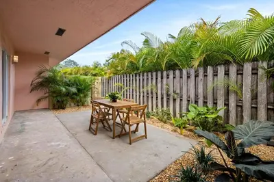 a patio with a table and chairs in front of a fence at Sailors Rest @ Sailboat Bend in Fort Lauderdale