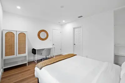 a white bedroom with a bed and a desk at Spacious 2 BR @Sailboat Bend in Fort Lauderdale