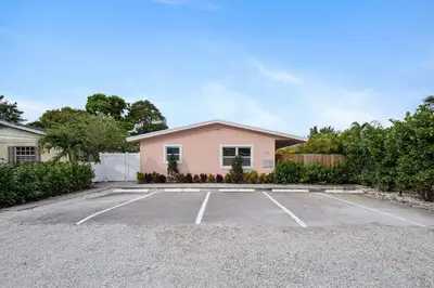 a pink house with a parking lot at Awesome 1BR Apartment @Sailboat in Fort Lauderdale