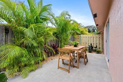 a patio with a table and two chairs and a fence at Awesome 1BR Apartment @Sailboat in Fort Lauderdale
