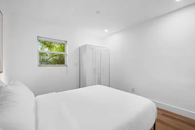a white bedroom with a bed and a window at Awesome 1BR Apartment @Sailboat in Fort Lauderdale