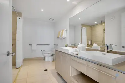 a large bathroom with two sinks and a toilet at Beach House Design in Hollywood