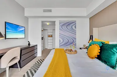 a bedroom with a large bed with a yellow blanket at Beach House Design in Hollywood