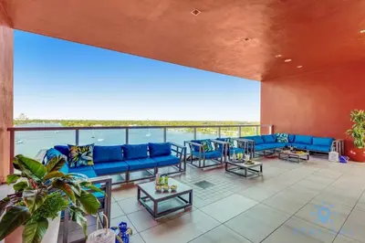 a large living room with blue couches and tables at Hollywood Bliss - Near Beach Studio - Rooftop Pool in Hollywood
