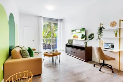 a living room with a couch and a table at Modern Luxury Retreat: Rooftop Pool Ocean Views in Hollywood