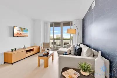 a living room with a couch and a table at Modern Condo - Amazing Pool - Gym - Balcony in Hallandale Beach
