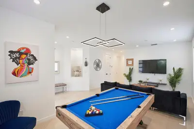a living room with a pool table in it at Modern New Construction Villa in Hollywood