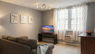a living room with a couch and a television at South Beach One Bedroom Condo with Parking Spot in Miami Beach