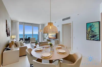 a dining room and living room with a table and chairs at Oceanfront Elegance - Sunset Views, Pet-Friendly in Hollywood