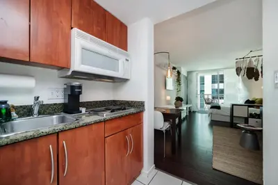 a kitchen with a sink and a microwave at FREE Dinner at Crazy About You Restaurant in Miami
