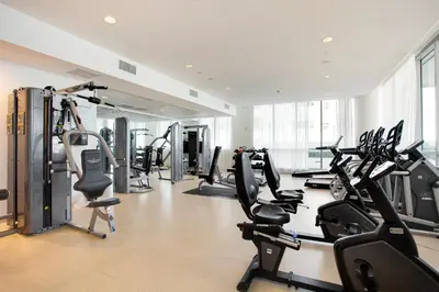 a gym with several treadmills and cardio machines at MonteCarlo Miami Beach in Miami Beach