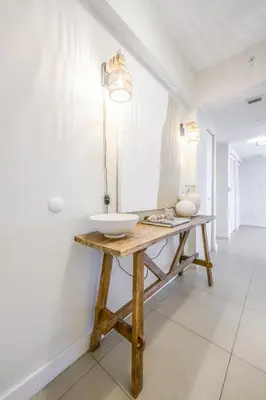 a bathroom with a wooden table with a bowl on it at MonteCarlo Miami Beach in Miami Beach
