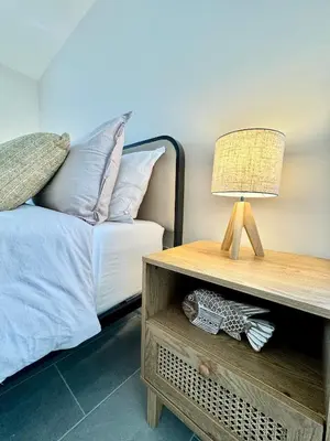 a bedroom with a bed and a table with a lamp at Modern / Central / Free Pkg in Miami Beach