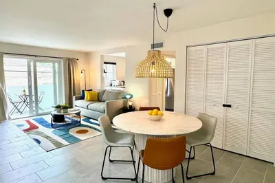 a living room with a table and chairs and a couch at Modern / Central / Free Pkg in Miami Beach