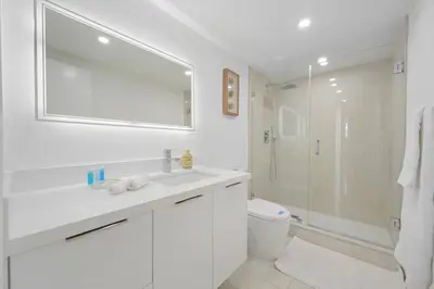 a white bathroom with a sink and a shower at Spacious apartment in Ocean Reserv of 2br - 2bth great price in Sunny Isles Beach