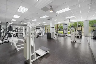 a gym with several treadmills and machines at Spacious apartment in Ocean Reserv of 2br - 2bth great price in Sunny Isles Beach