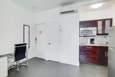 a kitchen with a desk and a chair in a room at Charming Large Studio Near Ocean Dr - South Beach in Miami Beach