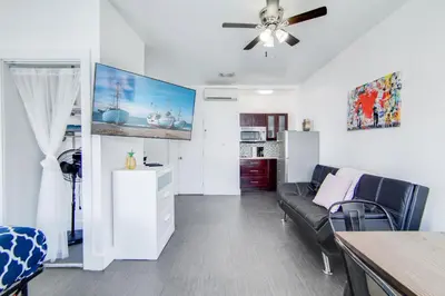 a living room with a couch and a table at Charming Large Studio Near Ocean Dr - South Beach in Miami Beach
