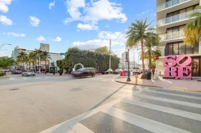an empty street with a stop light and a sign that says so at Cozy South Beach 1BR Apt Near Beach & Ocean Drive in Miami Beach