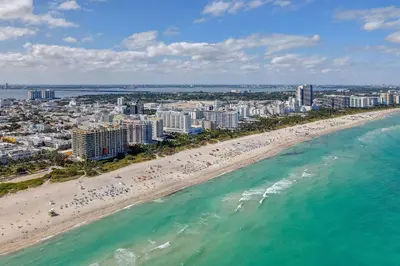 an aerial view of a beach and the ocean at Cozy South Beach 1BR Apt Near Beach & Ocean Drive in Miami Beach