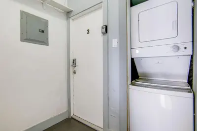 a small room with a door and a microwave at Comfy 1 B/R, Near Ocean Dr & Beach - South Beach in Miami Beach