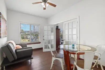 a living room with a glass table and a chair at South Beach 2BR with Private Balcony, Walk to Beach in Miami Beach