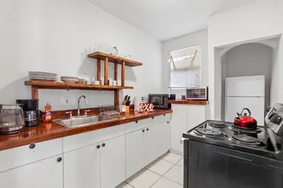 a kitchen with a sink and a stove top oven at South Beach 2BR with Private Balcony, Walk to Beach in Miami Beach
