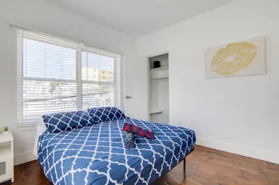 a bedroom with a bed with a blue comforter at 2 B/R- Heart of South Beach, Near Ocean Dr & Beach in Miami Beach