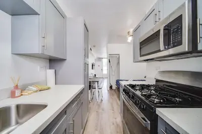 a kitchen with a sink and a stove top oven at Fun & Value Ocean Dr, South Beach, Steps to Beach in Miami Beach