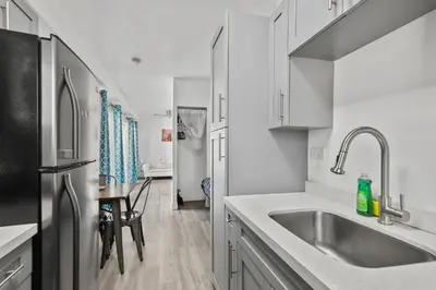 a kitchen with a sink and a refrigerator at Balcony Chic Apt, w/2 Queenbeds, on Ocean Dr Beach in Miami Beach