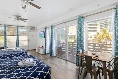 a bedroom with a bed and a table and a balcony at Balcony Beach View w/2 Queen beds, Ocean Dr Beach in Miami Beach