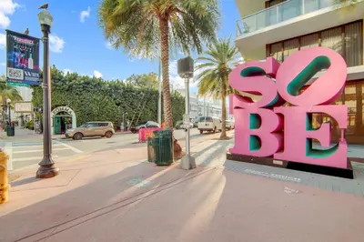 a large pink sign on the side of a street at Ocean Drive Comfy apt, w/2 Queen Beds by the Beach in Miami Beach