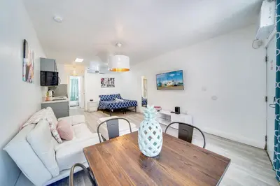 a living room with a table and a couch at Beachy 1 b/r, w/2 Queen Beds, On Ocean Drive Beach in Miami Beach