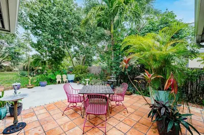 a patio with a table and chairs and trees at Uhost AI - Updated 1B1B Hideaway - Sleeps 3 in Hollywood