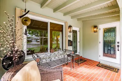 a screened in porch with a table and chairs at Uhost AI - Updated 1B1B Hideaway - Sleeps 3 in Hollywood