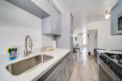 a kitchen with a sink and a stove at Deco Apt w/2 Queen Beds on Ocean Dr, South Beach in Miami Beach