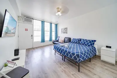 a bedroom with a bed and a couch in a room at Deco Apt w/2 Queen Beds on Ocean Dr, South Beach in Miami Beach