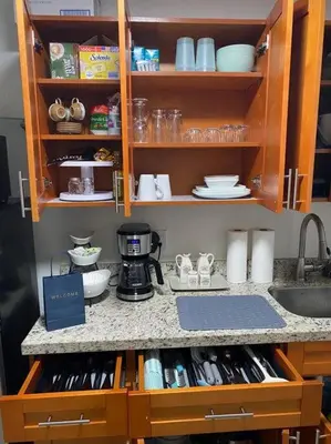 a kitchen counter with a sink and a counter top at Casita Cafe in Miami