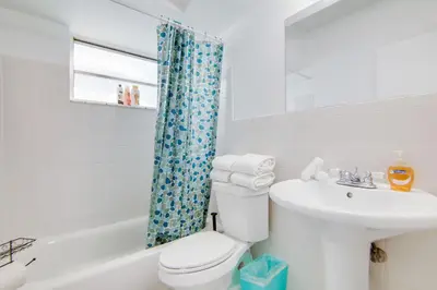a white bathroom with a toilet and a sink at Ocean Drive Best Deal, w/2 Queen Beds, Near Beach in Miami Beach
