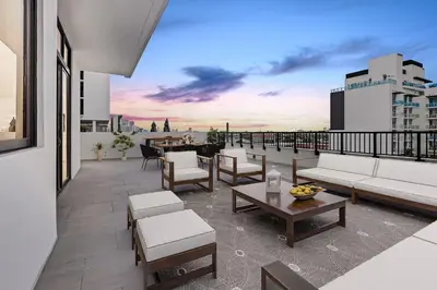 a balcony with couches and tables on a building at Wynwood 1br w gym pool wd nr shops bars MIA-34 in Miami