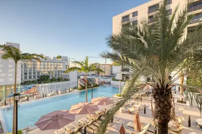 a swimming pool with a palm tree and buildings at Wynwood 1br w gym pool wd nr shops bars MIA-34 in Miami