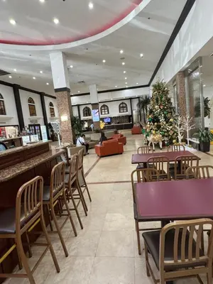 a restaurant with tables and chairs and a christmas tree at Miami Sunny Isles Beach Ocean Front Resort Condo with balcony Pool, Beach,Gym,Valet Parking in Sunny Isles Beach