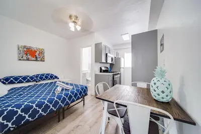 a bedroom with a bed and a table and chairs at Steps 2 Beach, Ocean Drive Deco Apt w/2 Queen Beds in Miami Beach