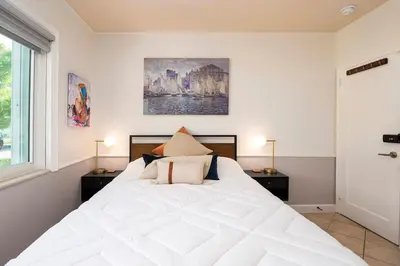 a bedroom with a large white bed with two night stands at Surfers Cove - Modern 3 2 w Pool near Calle 8 in Miami