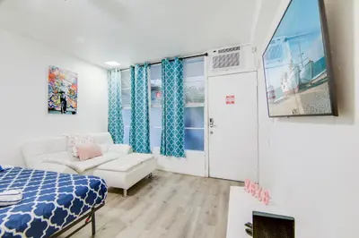 a living room with a bed and a couch at Super Beach Deal, Apt w/2 Queen Beds On Ocean Dr in Miami Beach