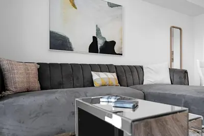 a living room with a gray couch and a table at Tranquil 1 Bed Escape in Doral With Free Parking in Hialeah Gardens