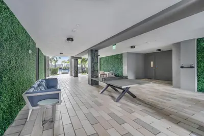 a living room with a ping pong table and green walls at Tranquil 1 Bed Escape in Doral With Free Parking in Hialeah Gardens