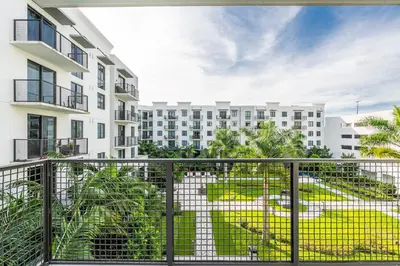 an apartment balcony with a view of a building at Sleek Doral Retreat 1 Bed Oasis With Free Parking in Hialeah Gardens