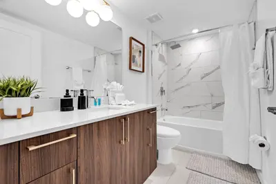 a bathroom with a sink and a tub and a toilet at Charming 3-Bed Mins from Brickell With Free Parking in Miami